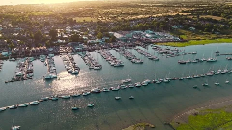 Aerial Mid Angle Pan Right Over Hamble Marina With Boats Docked At Sunset Stock Footage 314596828