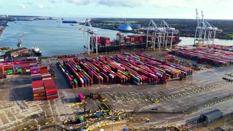 Aerial mid angle panning drone shot over cargo ship loading bay at river in Stock Footage 331126678