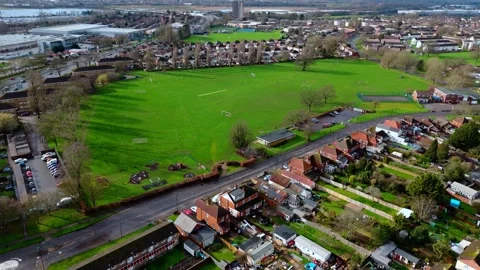 Aerial mid angle panning drone shot over Millbrook suburbs large field in Vídeos de archivo 331126989