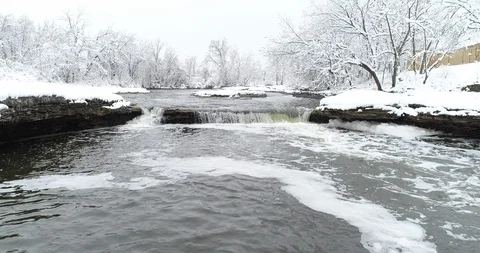 Aerial Midwest over small stream water fall and snow covered banks 库存影片 102533363