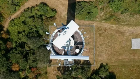 Aerial of military radar scanning on natural background of trees and paths Stock Footage
