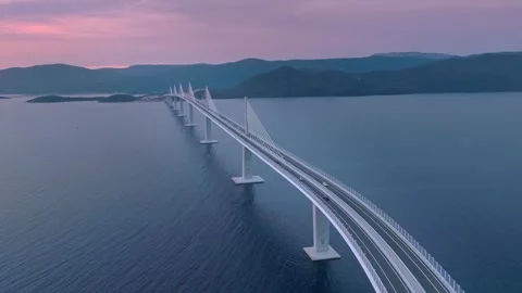 Aerial modern cable-stayed bridge spanning across calm Stock Footage 340124844