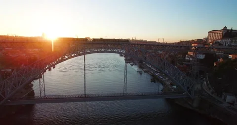 Aerial of modern train going over famous dom luis bridge in sunset, Porto Stock Footage 155249491