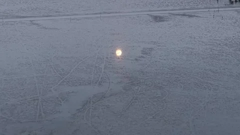 Aerial moon reflection over mud land with vehicle tracks Stock Footage 333049035