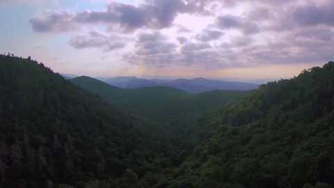 Aerial morning flying over the Blue Ridge Mountains in Asheville North Carolina Stock Footage