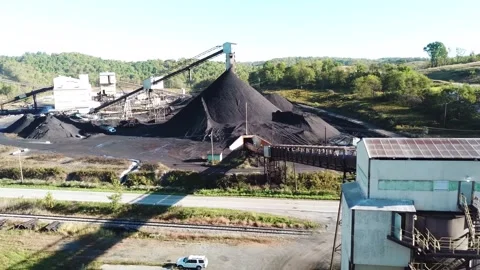 Aerial motion of an active coal mine and processing plant on a bright day i.. Stock Footage 337805035