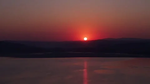 Aerial Motion of Dramatic Red Sunset Over Scenic River Stock Footage 332825341