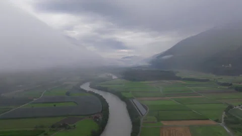 Aerial motion from right to left over river entering fog in Dolomites Austria Stock Footage 263907836