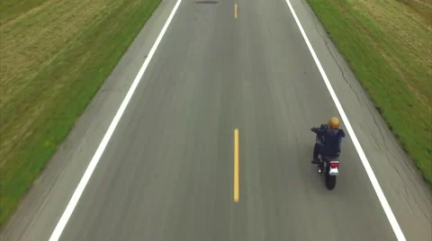 Aerial of motorcycle driving down road Vídeos de archivo 56207741