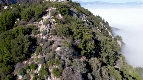 Aerial of Mount Wilson above the clouds fly over antenna tower Stock Footage 153052181