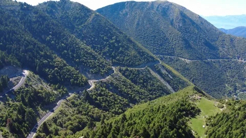 Aerial mountain landscape with deep ravines forest and remote road Stock Footage 343948156