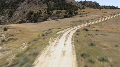 Aerial of mountain path, Flight Down Dirt Road In Terry Badlands Stock Footage 109460749