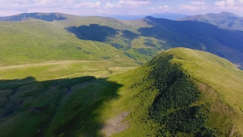 Aerial of a mountain peak with a cloud shade resembling cat in the Carpathians Stock Footage 93712399