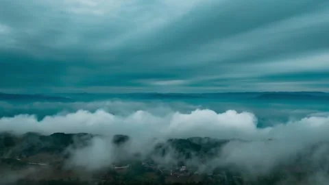 Aerial Mountain Peaks Emerging Through Morning Mist and Rolling Clouds Video stock 342213893
