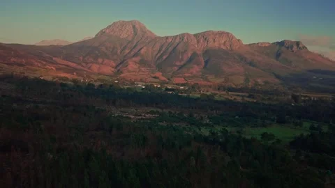 Aerial of a mountain range and green valley near Franschhoek Stock Footage 346712581