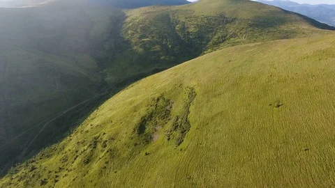 Aerial of mountain range looking like curling bear in the Carpathians in summer Stock Footage 93753530