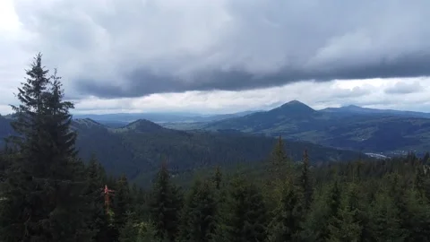 Aerial of mountain range with storm clouds In Pine Tree Forest during summer Stock Footage 218987245