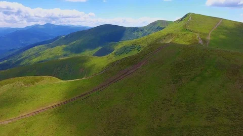 Aerial of a mountain range with two lengthy lanes in the Carpathians in summer Stock Footage 93648950