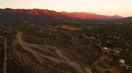Aerial Of Mountain Ranges And Scarcely Scattered Houses At Sunset Stock Footage
