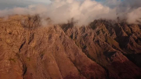 Aerial of a mountain ridge clearing over a valley near Franschhoek Stock Footage 346701168