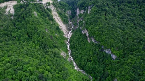 Aerial Mountain Road by Cascading Stream Stock Footage 256180698