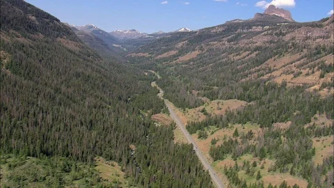 Aerial of mountain road through dense forest, Long lonely road in wooded Stock Footage 109465659
