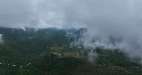 Aerial: mountains, trees and clouds during the day in a rural zone near Cetinje Stock Footage 309203322