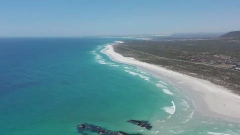 Aerial moving along the shoreline of Big Bay, Cape Town, South Africa. CAPE TOWN Stock Footage 155708853