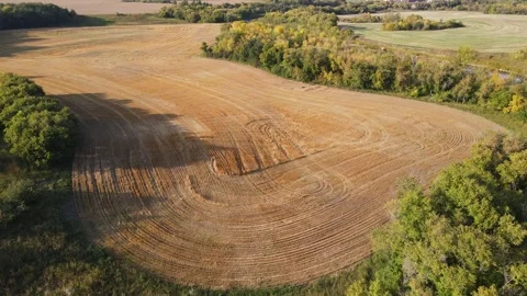 Aerial moving forward and looking down onto harvested farm fields  Stock Footage 249947317
