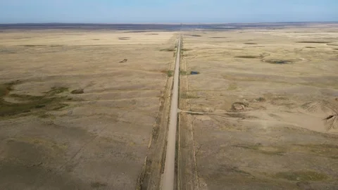 Aerial moving forward and looking down onto a dry barren prairie landscape  Stock Footage 255677371