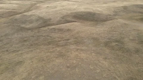 Aerial moving forward over dry rolling western ranch land with cattle trails Vídeo Stock 289028061