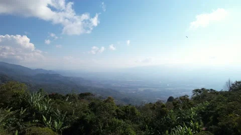 Aerial Moving Forward Over Lush Mountain Landscape With Bright Sky Vídeo Stock 233457604