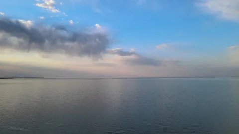 Aerial moving slowly forward low above a very large lake that has small waves.  Stock Footage 245952102