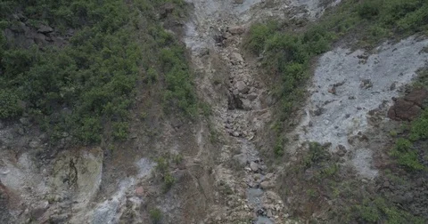 Aerial moving upstream towards the steaming sulphur deposits of Dominica Stock-Footage 78223301