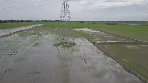 Aerial moving up view of high voltage electricity pylon in the farmland Stock Footage 92110108