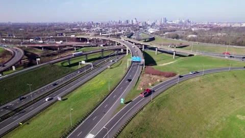 Aerial multi layer freeway crossing with panorama of Dutch city The Hague in Stockbeeldmateriaal 332627947