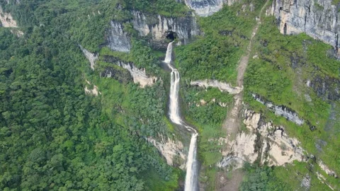 Aerial multi-tier waterfall on green cliff Stock Footage 331410686