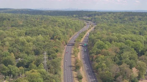 AERIAL: Multilane interstate expressway with New York cityline on the horizon Stock Footage 71567674