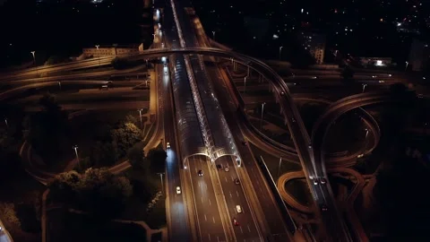 Aerial multiple roads junction. Drone shot city highway road junctions at night Video stock 199595944