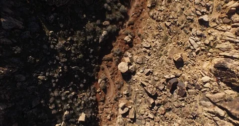 Aerial of narrow path between two rocky mountains Stock Footage 103827651