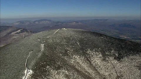Aerial of narrow path on the mountain top covered with snow, Rounded mountain Stock Footage 109138583