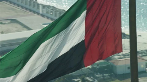Aerial National Flag flying Pole Urban District Dubai UAE Stock Footage