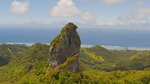 Aerial of The Needle rock surrounded by rainforest, Rarotonga, Cook Islands Stock Footage 137970744