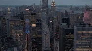 Aerial: New York City Skyscrapers And Busy Streets Lit Up With Lights At Night Stock Footage