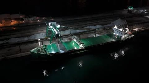 Aerial night cargo ship loading bulk material at industrial port Stock Footage 330531177