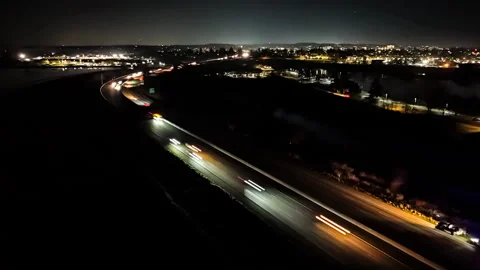 Aerial Night Hyperlapse of Busy Freeway Interchange with Traffic Light Trails Stock Footage 327041998