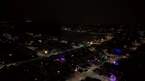 Aerial Night Pan down View of Snow Covered Residential area in Edmonton, Canada Видео 336354841