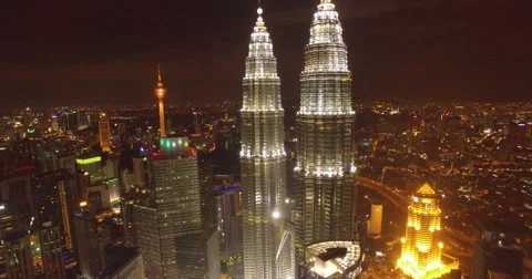 Aerial night shot of petronas towers in city of Kuala Lumpur, Malaysia Stock Footage