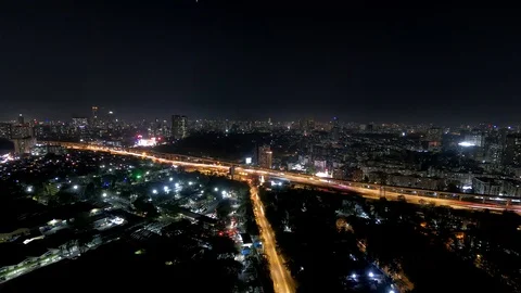 Aerial Night Timelapse of a busy intersection illuminated by cars, street lights Stock Footage 125479124