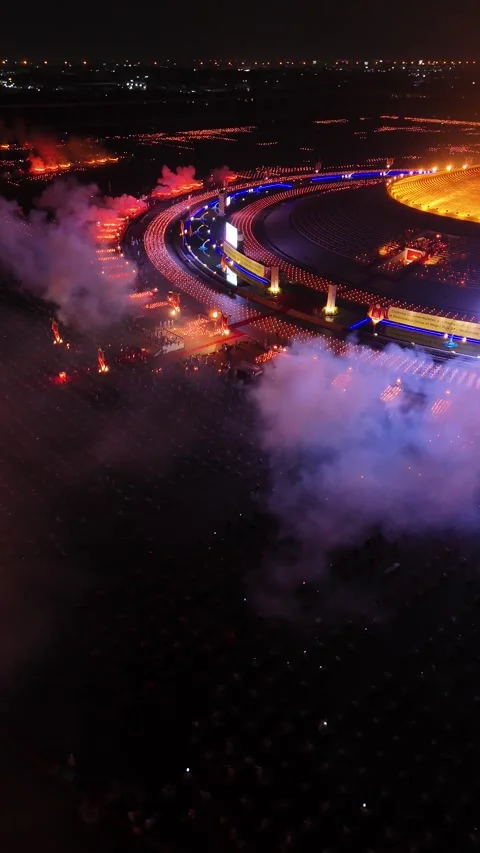 Aerial Night View of Buddhists Lighting Candles During Magha Puja Video stock 335941346